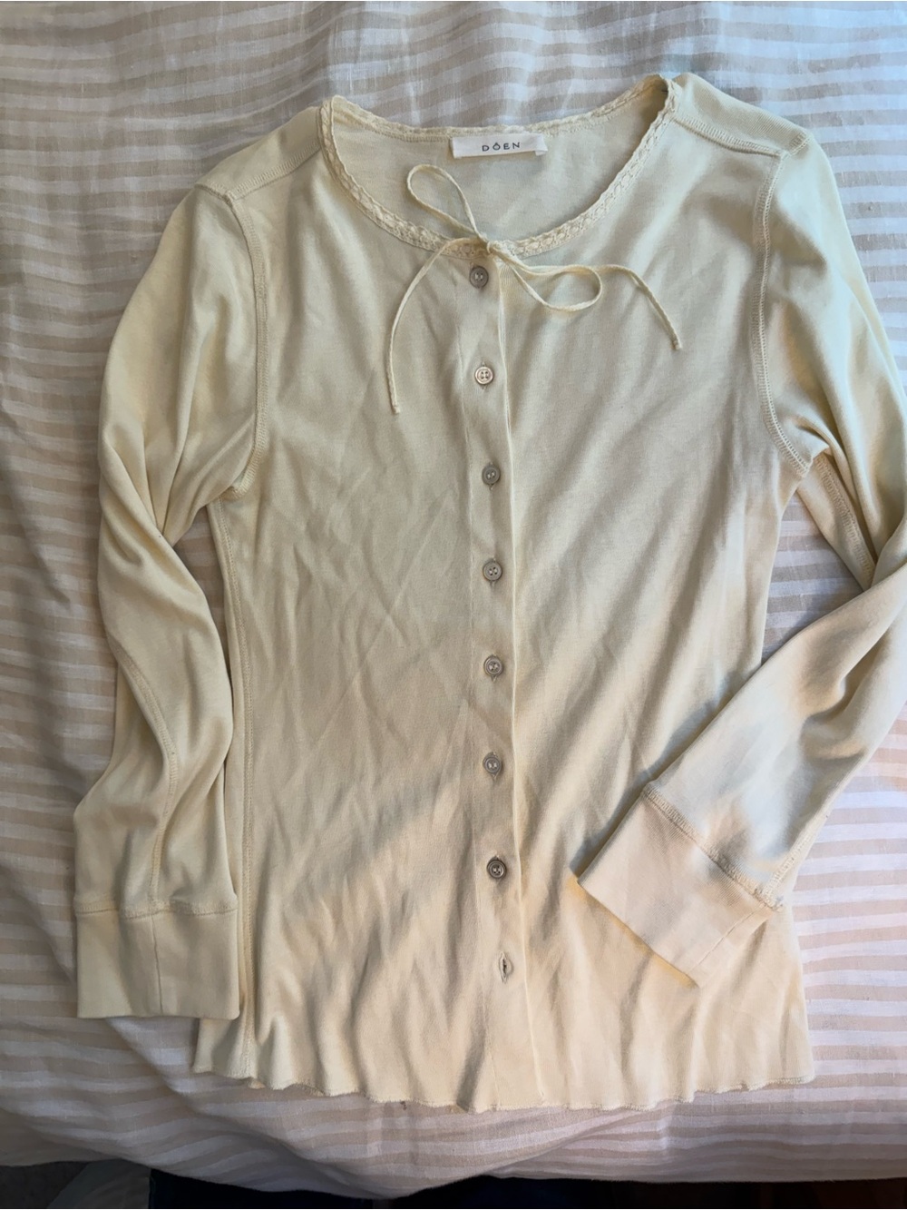 Dôen cream colored long sleeve tee with buttons down the front, size S